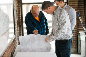 OMNI team looking at blueprints